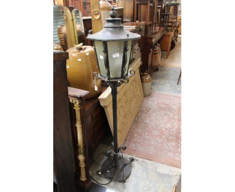 A cast and wrought iron lamp post and lamp 