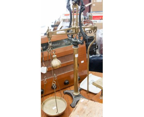 A set of chemists scales, brass and cast iron with porcelain plate, J White and Son 