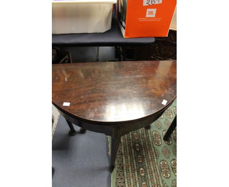 A good early 18th century mahogany demi lune fold over tea table, circa 1720, on tapered turned supports, on pad feet with ga