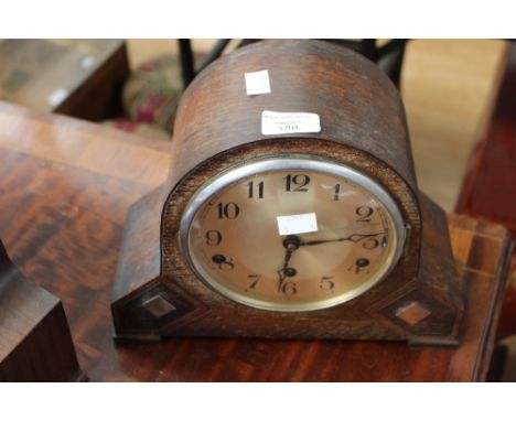 A 1920s mantel clock, wooden domed case