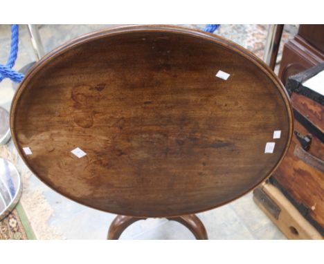 A George II style mahogany tripod table, raised on a turned column and standing on three splayed legs