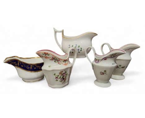 A Newhall helmet shaped fluted cream jug, painted with floral sprigs, 12cm high, c.1790; another, painted with a basket, 11.5