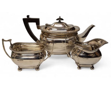 A George VI silver three piece boat shaped tea service, comprising teapot, milk jug and sugar bowl, John Dixon &amp; Sons, Sh