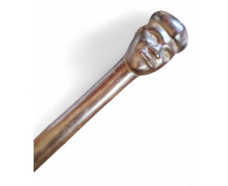 A 19th century African tribal walking stick, the pommel carved with a head, 91.5cm long