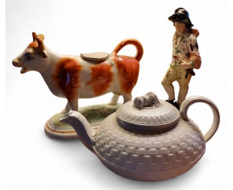 An early 19th century Pratt Ware figure,&nbsp; Fire, of a man, standing, wearing a black hat&nbsp; holding a flaming torch, s