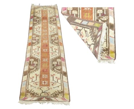 An early 20th century Milas Turkish runner, neutral tones of terracotta, red, gold, brown and cream, 265cm x 67cm