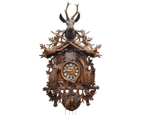 A fine 19th century Black Forest carved limewood spring driven cuckoo clock, Jagdstück/hunt piece, the case with stag's head 