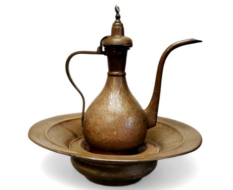 An antique Islamic ewer and basin,&nbsp; profusely decorated in relief with scripture, flora, fauna, crowned figures and figu