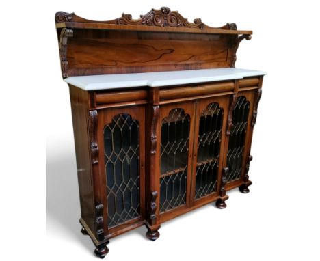 An early 19th century rosewood breakfront chiffonier, the raised back with three quarter gallery, Carrara marble surface over