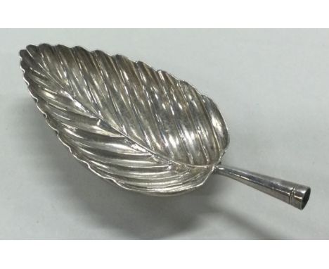 A Georgian silver leaf shaped fluted caddy spoon. Circa 1800. Approx. 6 grams. Est. £20 - £30.