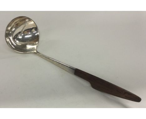 A fine Danish silver ladle with wooden handle. Marked to base. Approx. 56 grams. Est. £80 - £120.