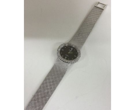 ROLEX: A fine quality 18 carat gold Cellini wristwatch with black dial and diamond bezel. Approx. 63 grams. Est. £4500 - £500