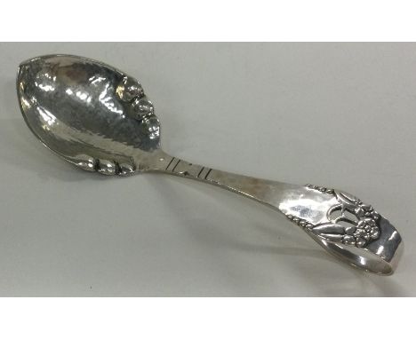 A Danish silver caddy spoon with hammered decoration. Approx. 26 grams. Est. £40 - £60.