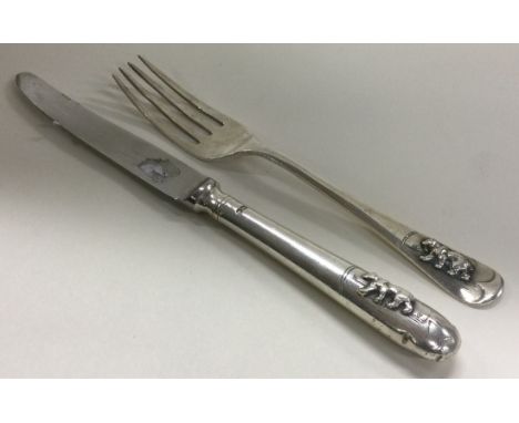 A silver christening knife and fork embossed with bears. Sheffield 1967. By Elkington & Co. Approx. 61 grams. Est. £50 - £80.