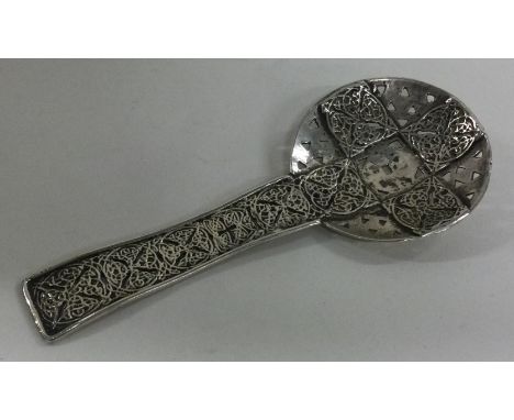 A Dutch silver chased caddy spoon. Marked to front. Approx. 43 grams. Est. £30 - £50.