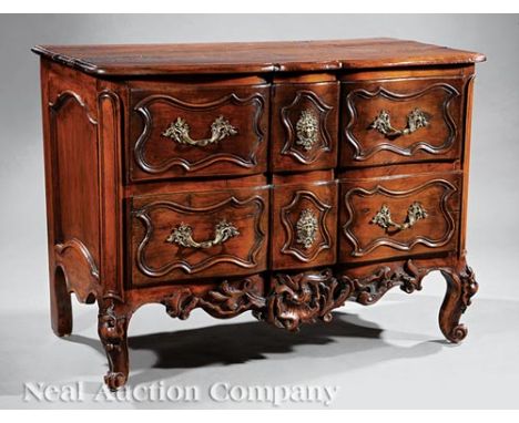 Louis XV Provincial Highly Carved Walnut Commode, 18th c., shaped top, conforming blocked drawers, shell-carved skirt, cabrio