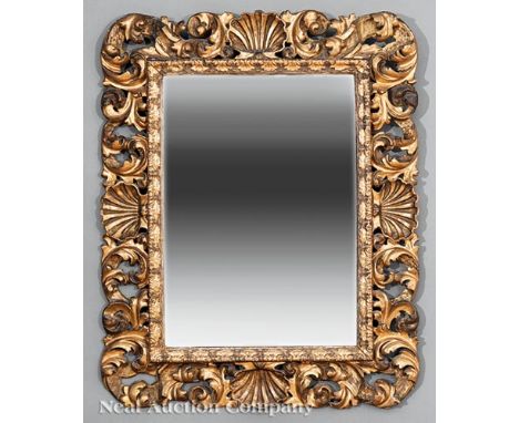 Continental Carved and Gilded Mirror, 19th c., reticulated shell and leaf surround     