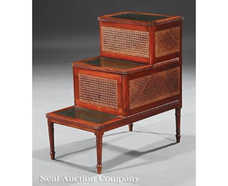 Sheraton Carved Mahogany Bedstep, probably 19th c., leather inset treads with hinged tops, center commode, caned panels, turn