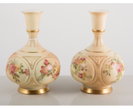 Pair of Royal Worcester bottle vases, the fields painted with roses and primulas, numbered to underside 1671, 16cm tall.