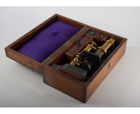 Victorian lacquered brass monocular microscope, with accessories, unsigned, in mahogany box inset with brass presentation pla