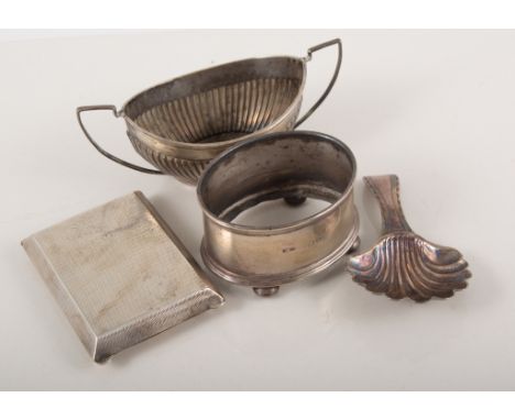 A silver caddy spoon with shell bowl, silver book match holder with engine turned pattern, silver and mother-of-pearl fruit k