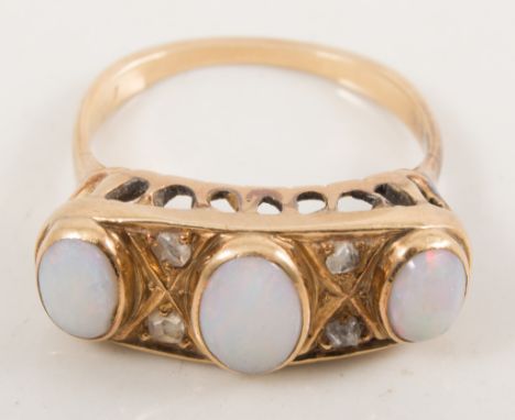 An opal dress ring, the three oval cabochon cut stones spaced by two pairs of rose cut diamonds in an all yellow metal half h