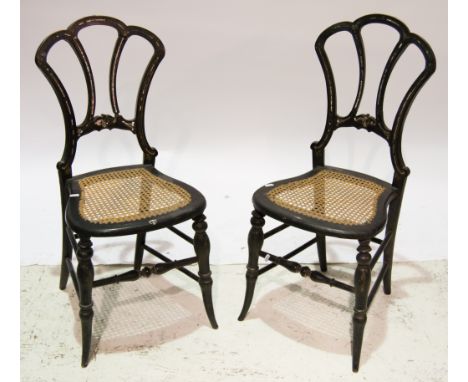 Pair of Victorian ebonised bedroom chairs, open shell shaped backs inlaid with traces of mother of pearl, rattan seats, turne