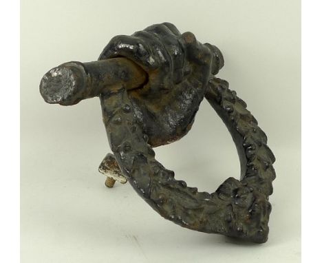 A 19th century English cast iron door knocker modelled in the form of a hand holding a wreath, 19 by 17 by 7cm.