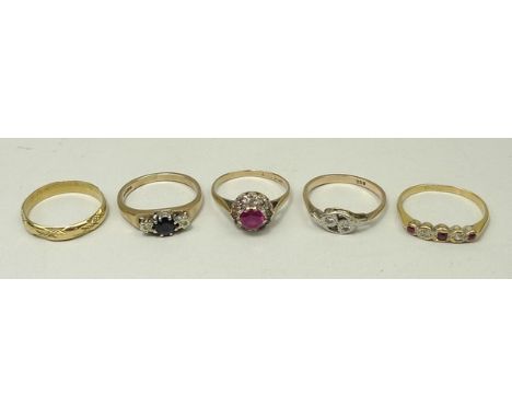 An 18ct gold ruby and diamond five stone ring, size L, a 1930's 9ct gold and diamond set cross over ring, size L, a 9ct gold 