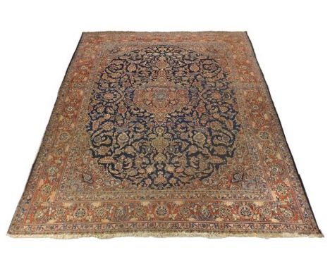 A large Persian rug with blue central medallion on a pink ground, 370 by 270cm.