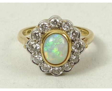 An 18ct gold, opal and diamond ring, opal approximately 0.7ct, diamonds 0.4ct, size M, 5.2g. 