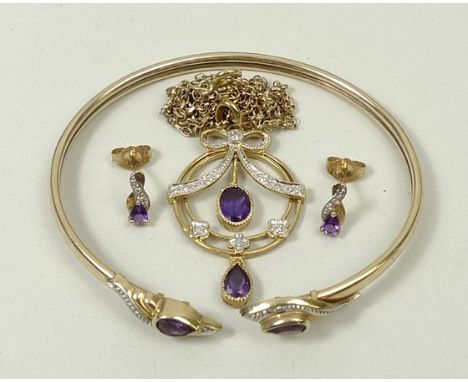 A parure of 9ct gold, amethyst and diamonds, the pendant having a diamond encrusted bow above a suspended amethyst, the earri