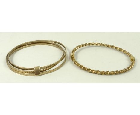 A 9ct rope twist bangle on a snap clasp and an engraved triple loop bangle with a link attachment, 24.1g