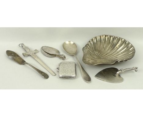 A silver vesta case with engraved foliate decoration, Birmingham 1925, bent silver spoon paper clip, further spoon, butter kn
