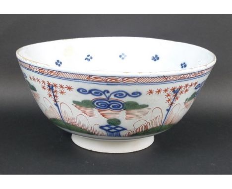 An English polychrome Delftware bowl, late 18th century, painted with a repeating band of stylised flowers and leaves within 