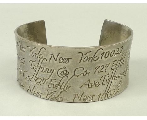 A silver cuff bangle, the concave surface decorated throughout with incised 'Tiffany and Co 727 Fifth Ave New York, New York 
