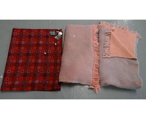 A burgandy ground woollen Welsh tapestry Melin Tregwynt Centenary blanket (150x180cm) with original labels, together with two