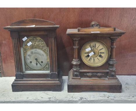 Two early 20th century two train architectural design mantle clocks, one with silvered face, the other with Roman numerals.  