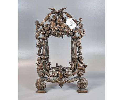 Rococo style oxidised metal openwork photograph/mirror frame decorated with cherubs, birds and foliage.  65cm high approx.  (