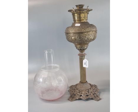 Early 20th Century oil burner lamp, having etched globular shade above a brass repousse reservoir on cast metal base. (B.P. 2