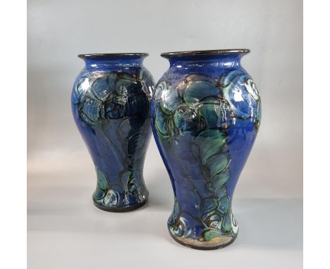 Pair of Danico, Denmark Art Pottery blue ground floral and foliate vases, impressed marks to the underside. 26.5cm high appro