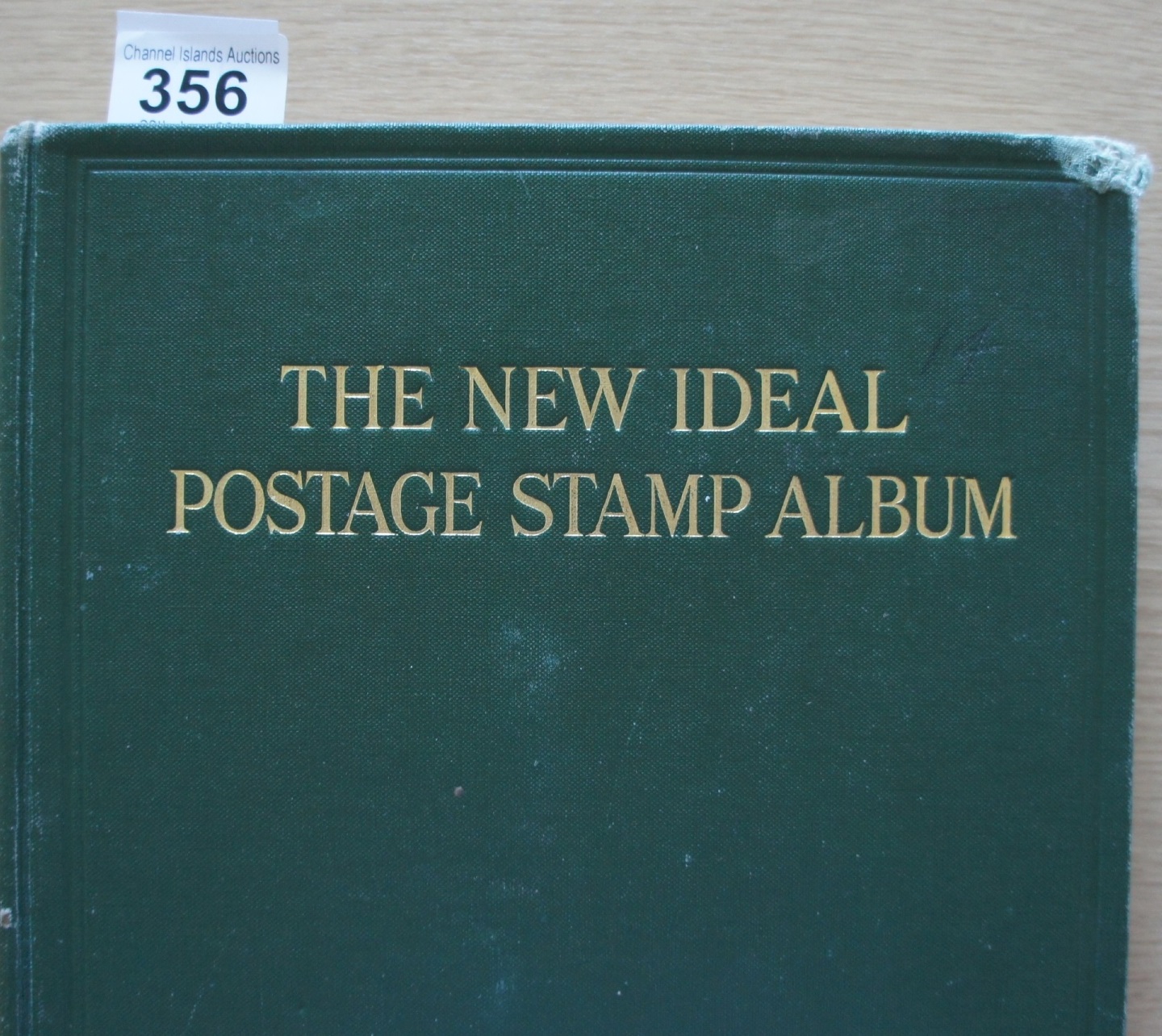The New Ideal Postage stamp Album British Empire, with various stamps enclosed.