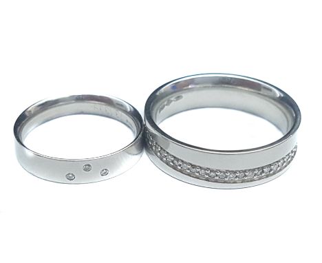Two platinum wedding bands, one set with offset band of diamonds, the smaller band with a group of three stones, ring sizes R