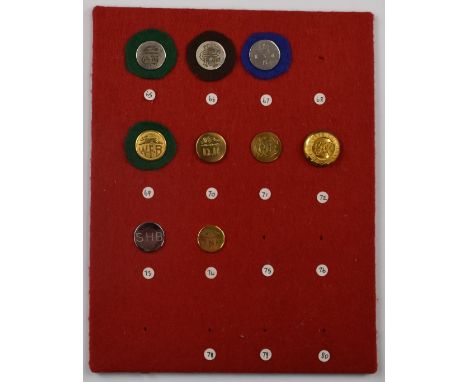 Nine vintage hunt/hunting buttons mounted on a felt covered display board including Cambridgeshire Harriers, Eton College Bea
