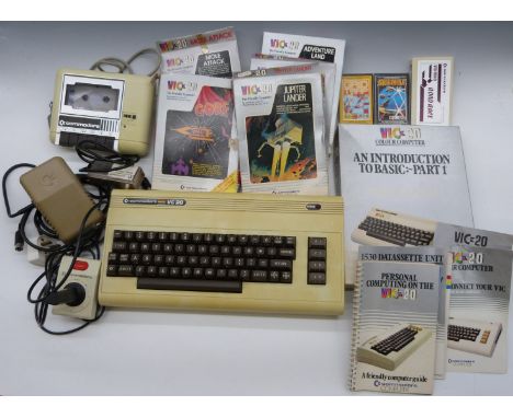 Commodore VIC-20 / VC-20 home computer together with power supply, cassette deck, joystick, manual and cartridge and cassette