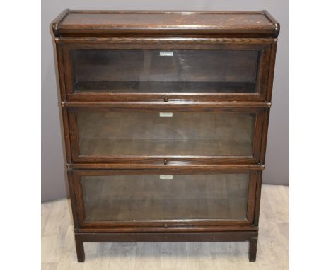 Globe Wernicke oak three tier bookcase with up and over glazed doors, W87 x D26 x H114cm