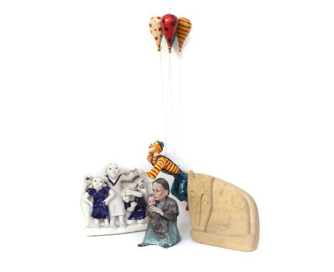 A 20th Century Polychrome Painted Papier Mache Clown, holding a bunch of balloons, a papier mache Holocaust group, of a mothe