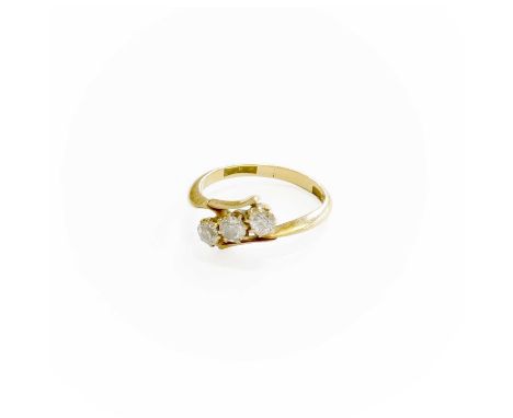 A Diamond Three Stone Twist Ring, the old cut diamonds positioned diagonally, in yellow claw settings, to a twist shoulder pl