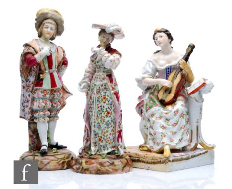 An early 20th Century Dresden type figure modelled as a seated lady playing a guitar with sheet music to her side, underglaze