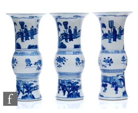 A garniture of Chinese Kangxi style blue and white beaker vases (gu), each similarly decorated with central lotus banding to 
